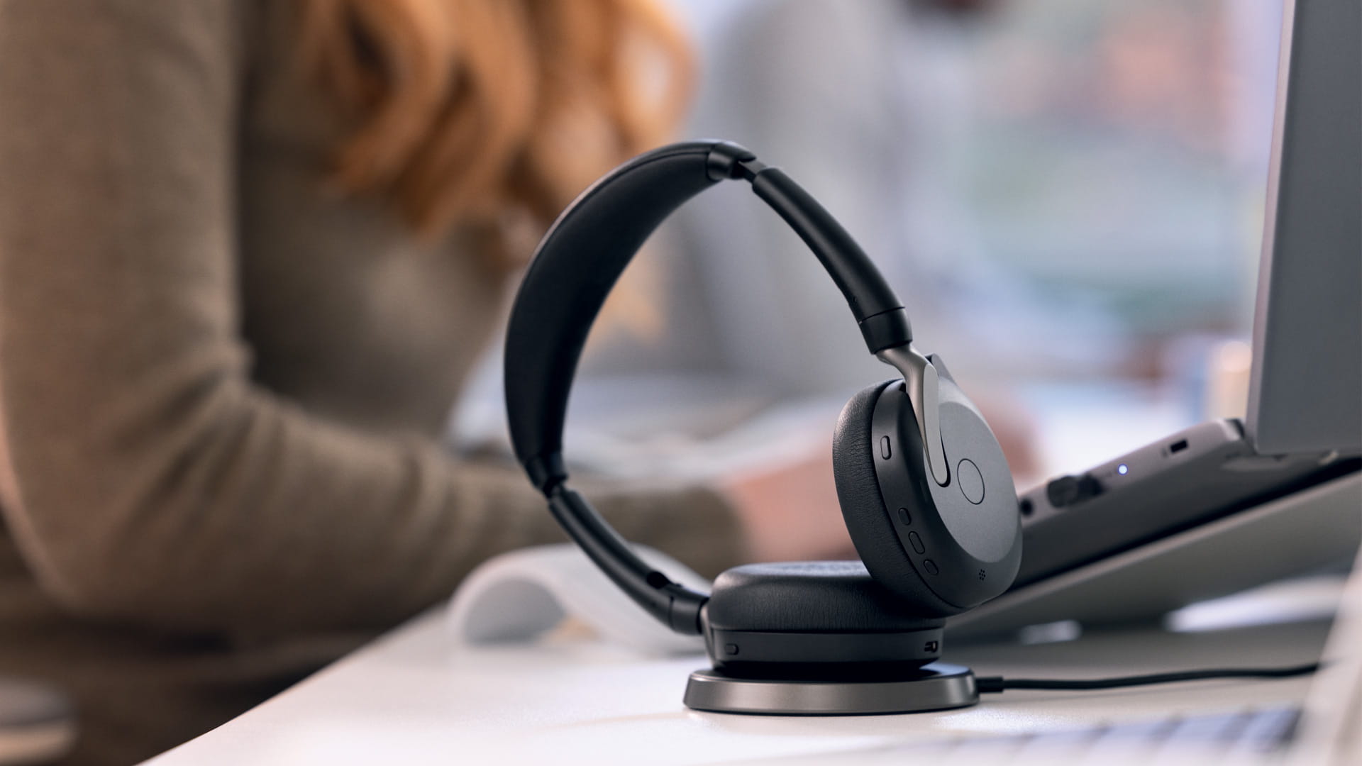 Headset on the table next to a screen