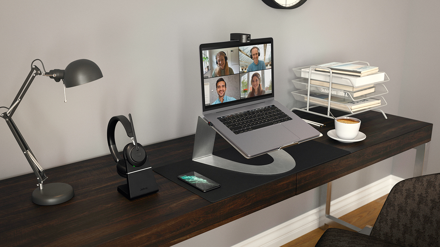 Image shows a laptop stand holding a laptop — a recommended remote work equipment.