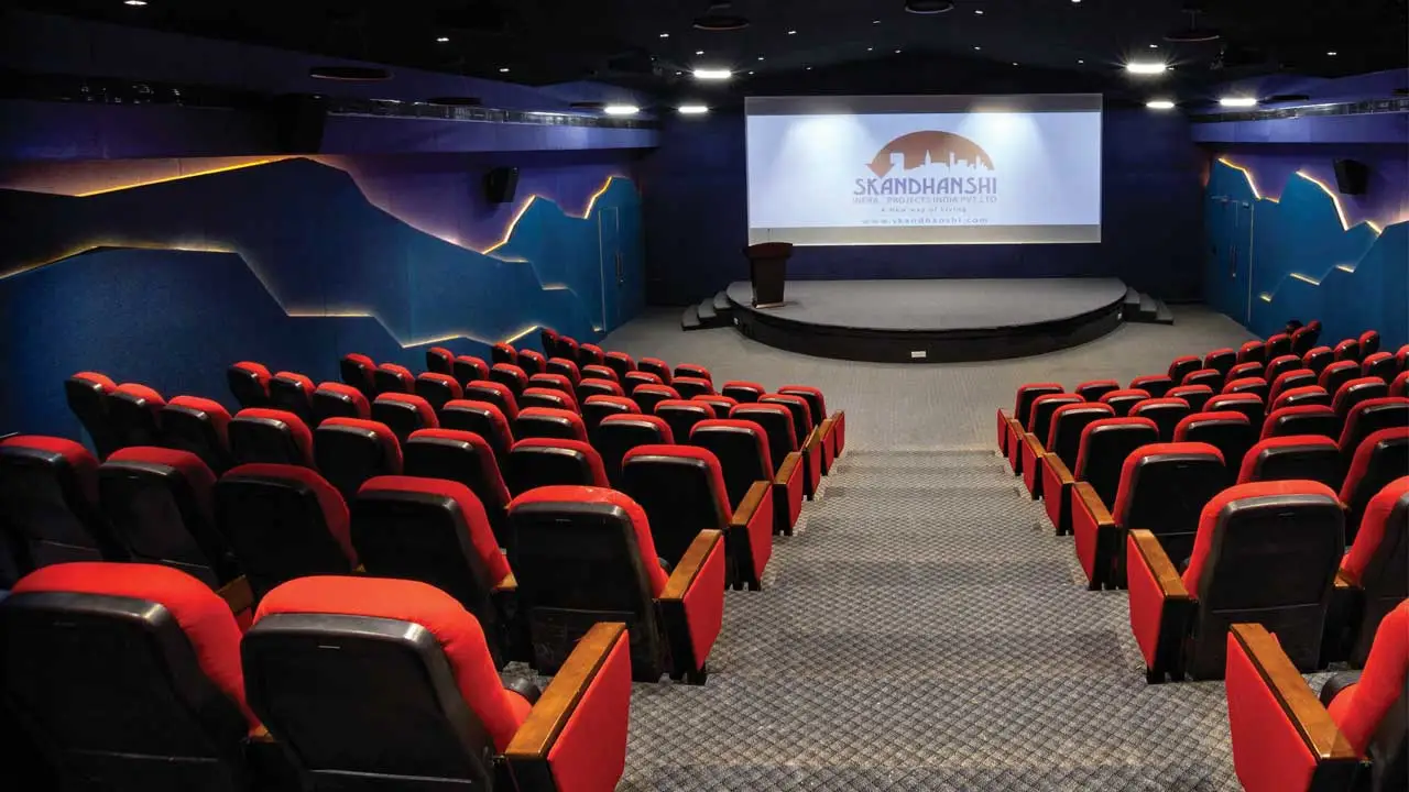 Auditorium style conference room with red chairs. Source: https://www.dious-furniture.com/news/Skandanshi-infra-projects-India