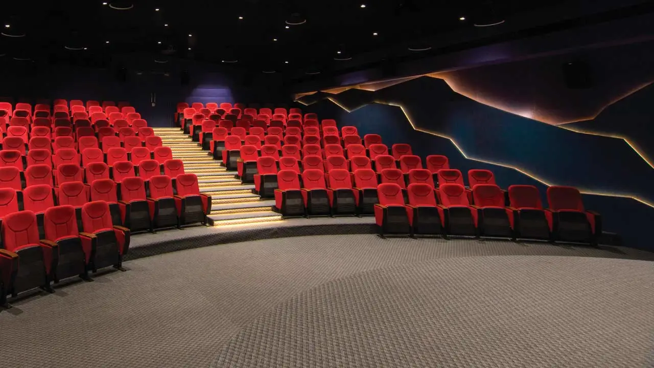 Auditorium style conference room with red chairs. Source: https://www.dious-furniture.com/modern-meeting-room-setup-styles